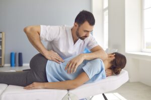 physical therapist working on a woman's back